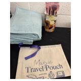 Blue towels with travel makeup pouch and makeup