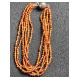Multi-strand bracelet; coral colored beads