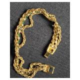 Gold tone bracelet w/small green glassy stones