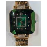Gold tone watch; green face w/beveled crystal