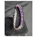 Sterling Silver Tennis bracelet w/purple stones.