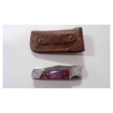 Damascus steel folding pocket knife with sheath.