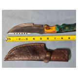 Serrated straight blade knife w/thumb rest.