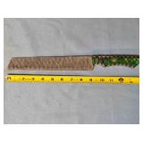 Serrated blade bread knife. Carved wood handle.