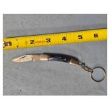 Folding knife w/keychain. Wood handle.