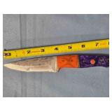 Drop point knife w/embossed leather sheath.