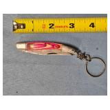 Folding knife w/keychain. Wood handle.