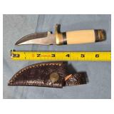 Trailing point blade knife w/guard. Light jimping