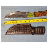 Serrated straight blade knife w/thumb rest.