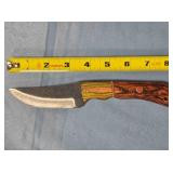 Trailing point knife w/wood handle & thong hole.