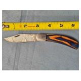 Folding Bowie-style blade knife. Wood handle.