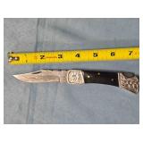 Lockback folding knife w/Bowie-style blade.