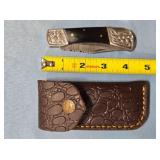 Lockback folding knife w/jimping on spine.