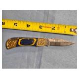 Lockback folding knife.  Jimping on spine