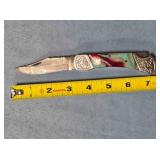 Lockback folding knife w/jimping on spine.