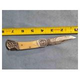 Lockback knife w/jimping on spine.