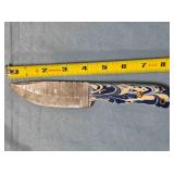 Drop point knife. Composite handle w/thong hole.