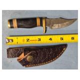 Clip point knife w/jimping & guard. Damascus steel