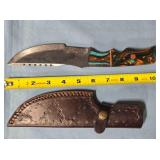 Straight blade knife w/serrated spine.