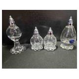 4 salt & pepper shakers. 1 round set. 1 stemmed.