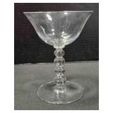 Four bead tall flared glass sherbet dish. 5" tall.