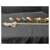7 cattle figurines; 2 have broken horns