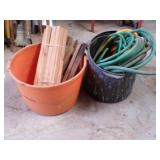 2- tubs of wood stakes & garden hose