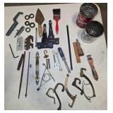 Chain saw parts, coat hangers, wrenches, scraper