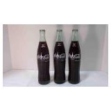 3 full pint of Coca-Cola bottles