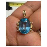 14K gold pendant w/ large oval blue topaz stone