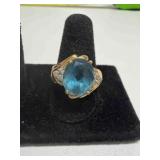 14K gold bypass diamond ring w/ oval blue topaz