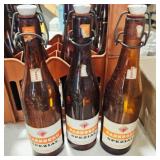 12 amber beer bottles w/porcelain snap tops