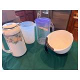 cabinet full of Ice maker, pitchers, etc