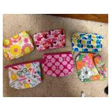 Box of ladies colorful makeup bags