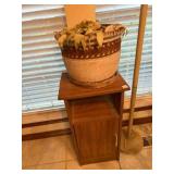 small wood cabinet and pole lamp