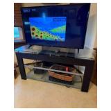 glass top television stand wit LG 42" flat screen,