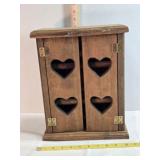 Wooden cabinet w/3 shelves, heart cutouts on doors