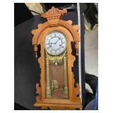 Carved wood wall clock w/brass pendulum, 33" tall