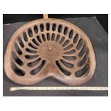 Large cast metal implement seat, intact