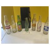 Seven vintage drink bottles, including Dale