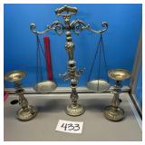 The scales of justice and two candleholders