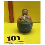 Vintage terra-cotta pottery fat man playing flute