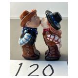 Cowboy and cowgirl, kissing salt and pepper