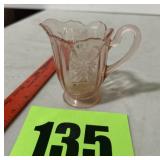 Pink creamer, very small chip on the bottom