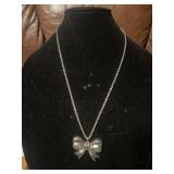 Silver Toned Necklace With Bow Pendant