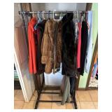 Clothing rack with furs and misc