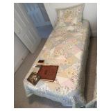 Single bed with linens and frame