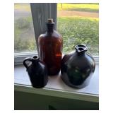 Stoneware jugs and amber glass jar