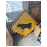 Large metal cow sign