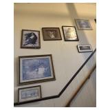 Framed prints on stair case wall